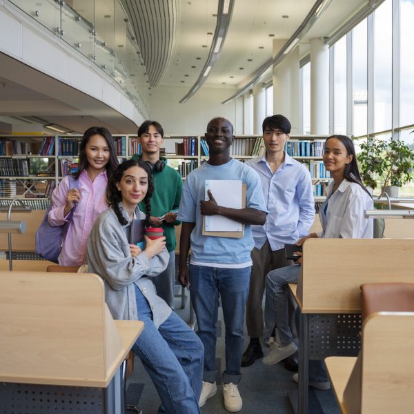 full-shot-smiley-students-library