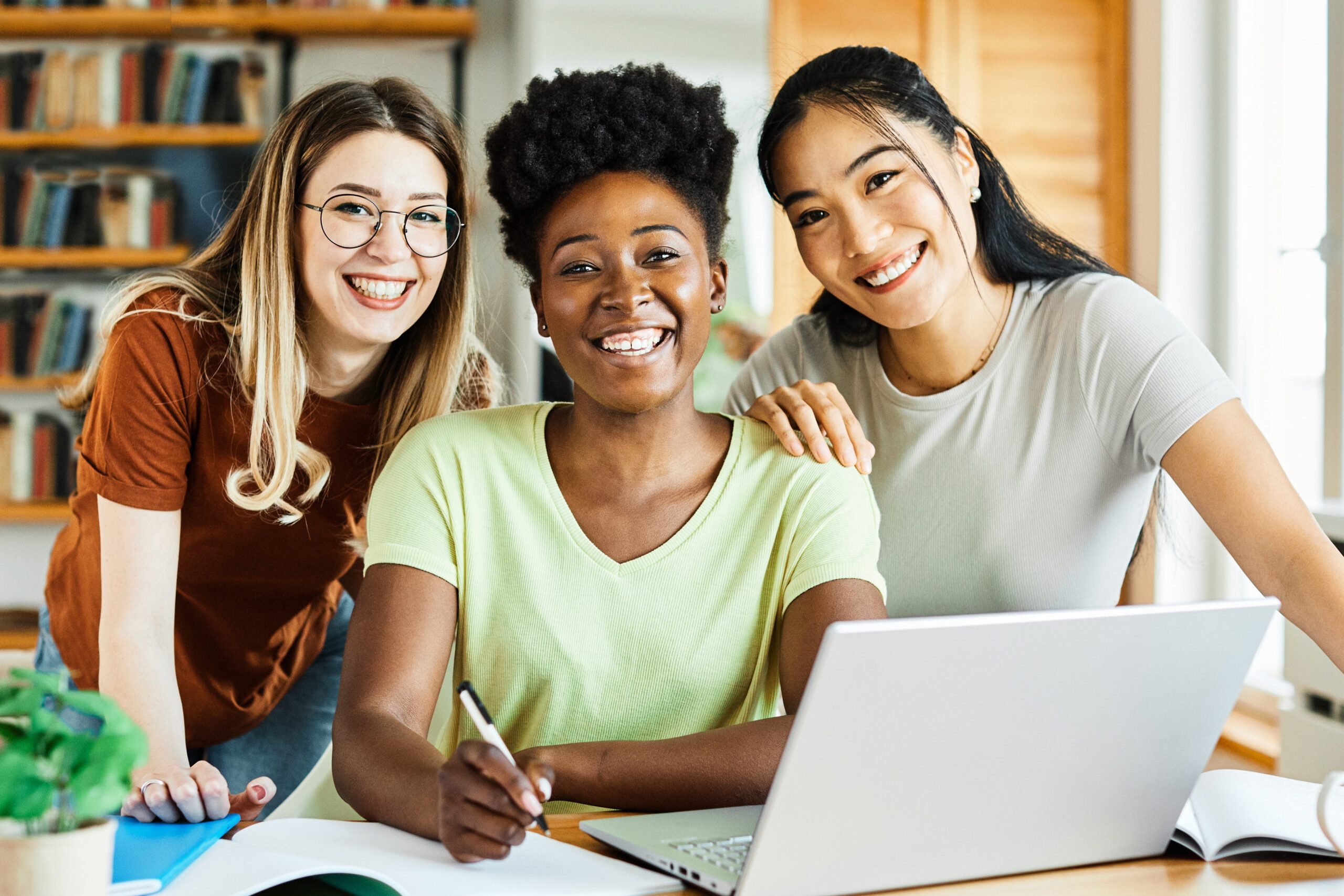 Portrait of a young happy girls using laptop at home or in the office